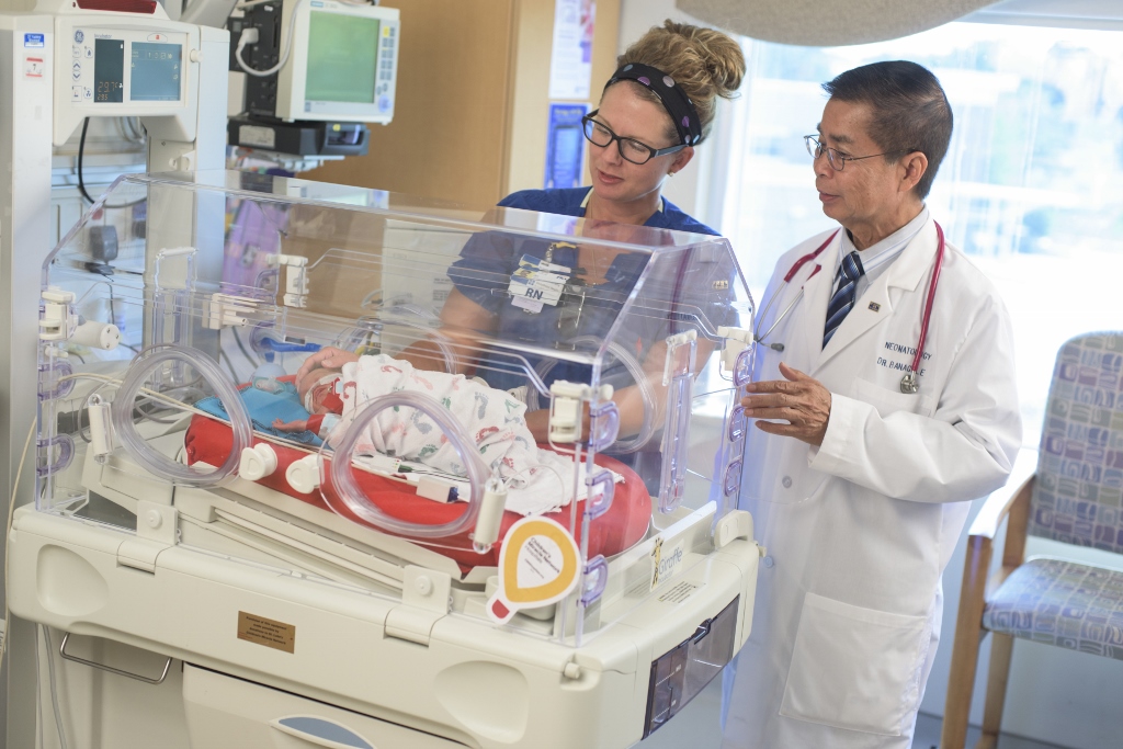 Doctor and nurse with baby in NICU